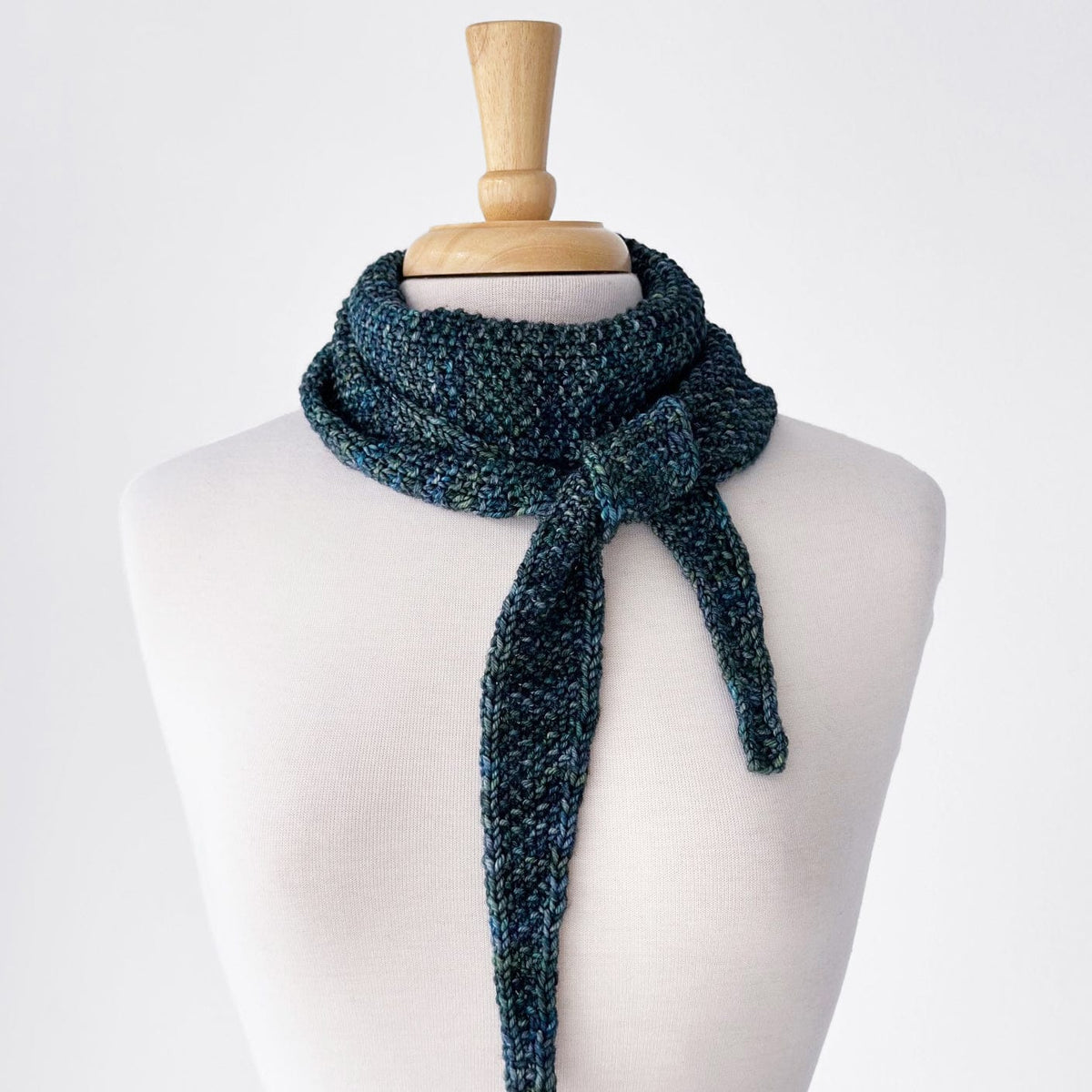Knitted blue scarf on a mannequin