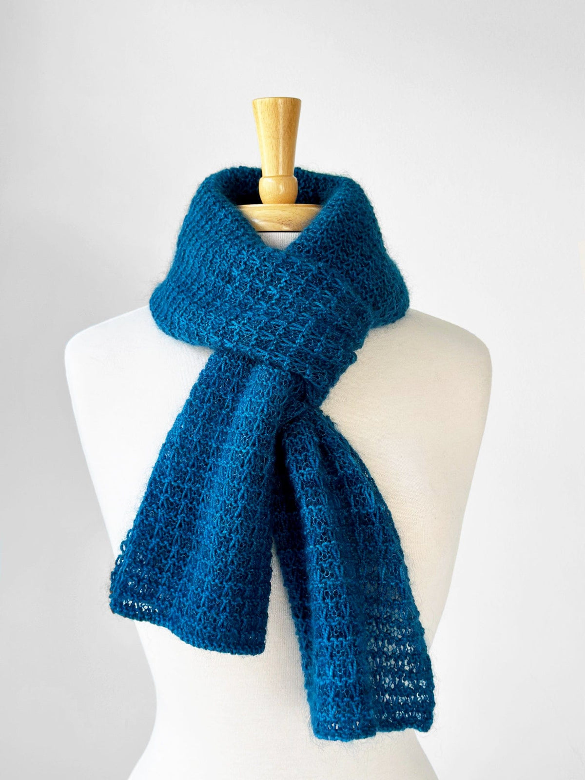 Blue knitted scarf on a mannequin