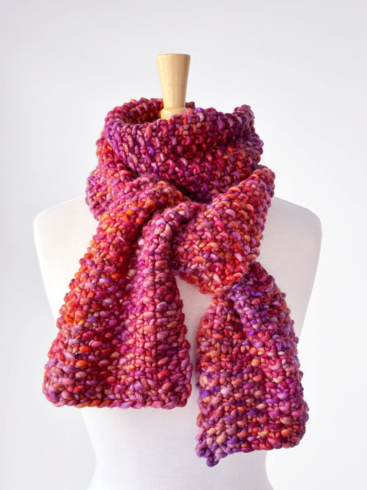Bulky seed stitch scarf in vibrant colors on a mannequin