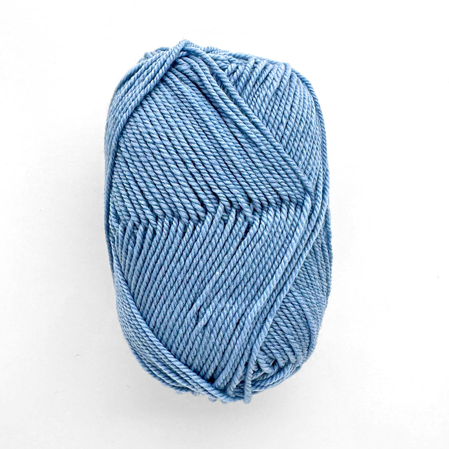 Light blue skein of yarn on a white background
