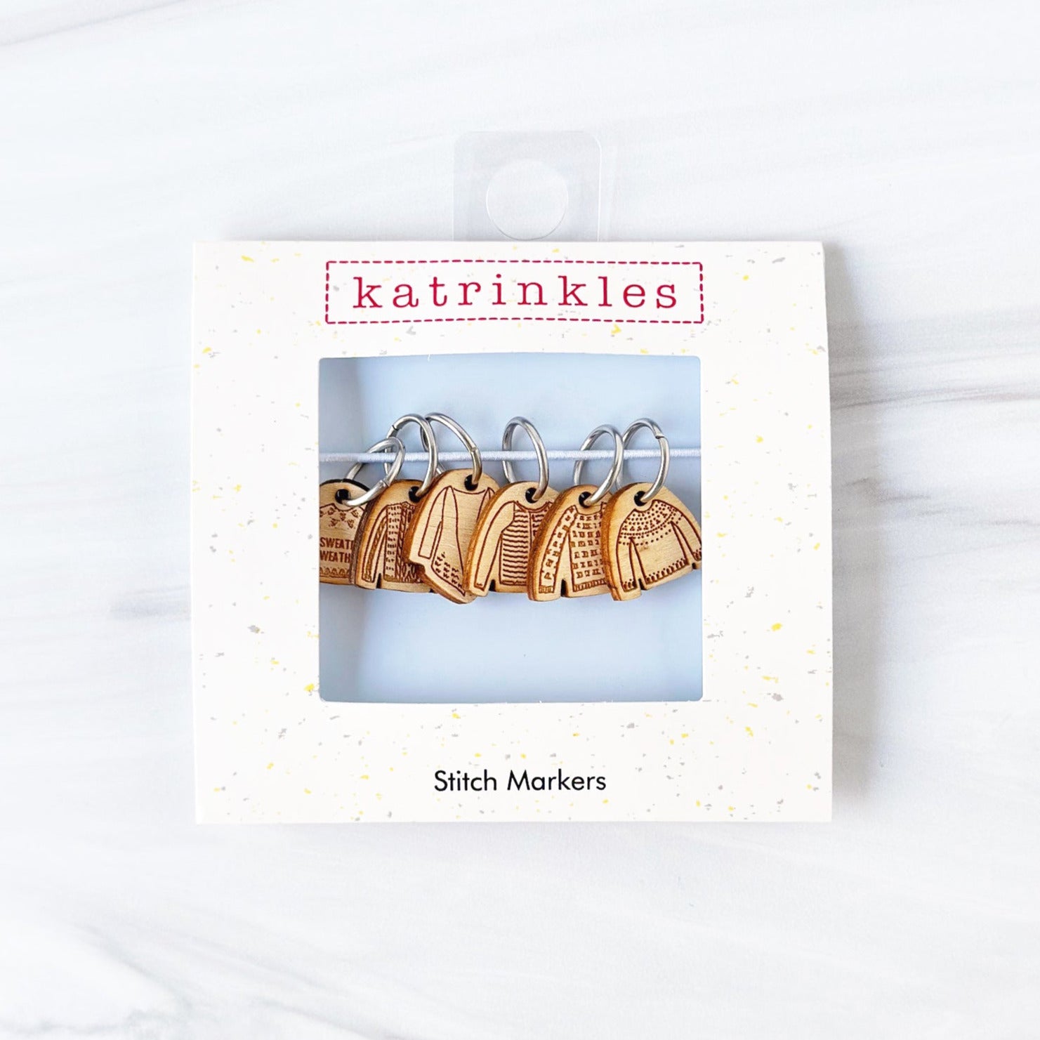 birch wood stitch markers featuring different sweater designs