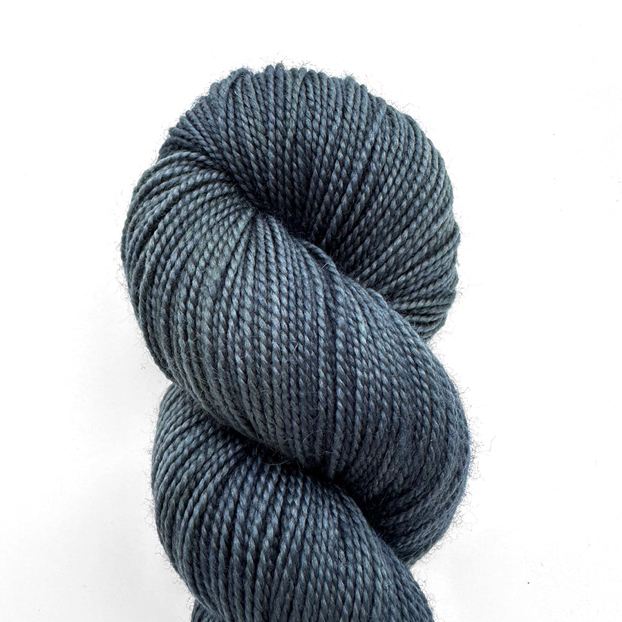 Loop Sprig Storm yarn skein in blue-gray