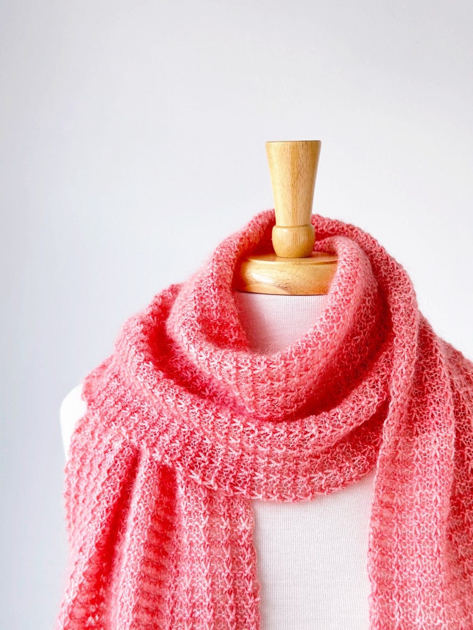 Pink lemonade loop scarf on a mannequin