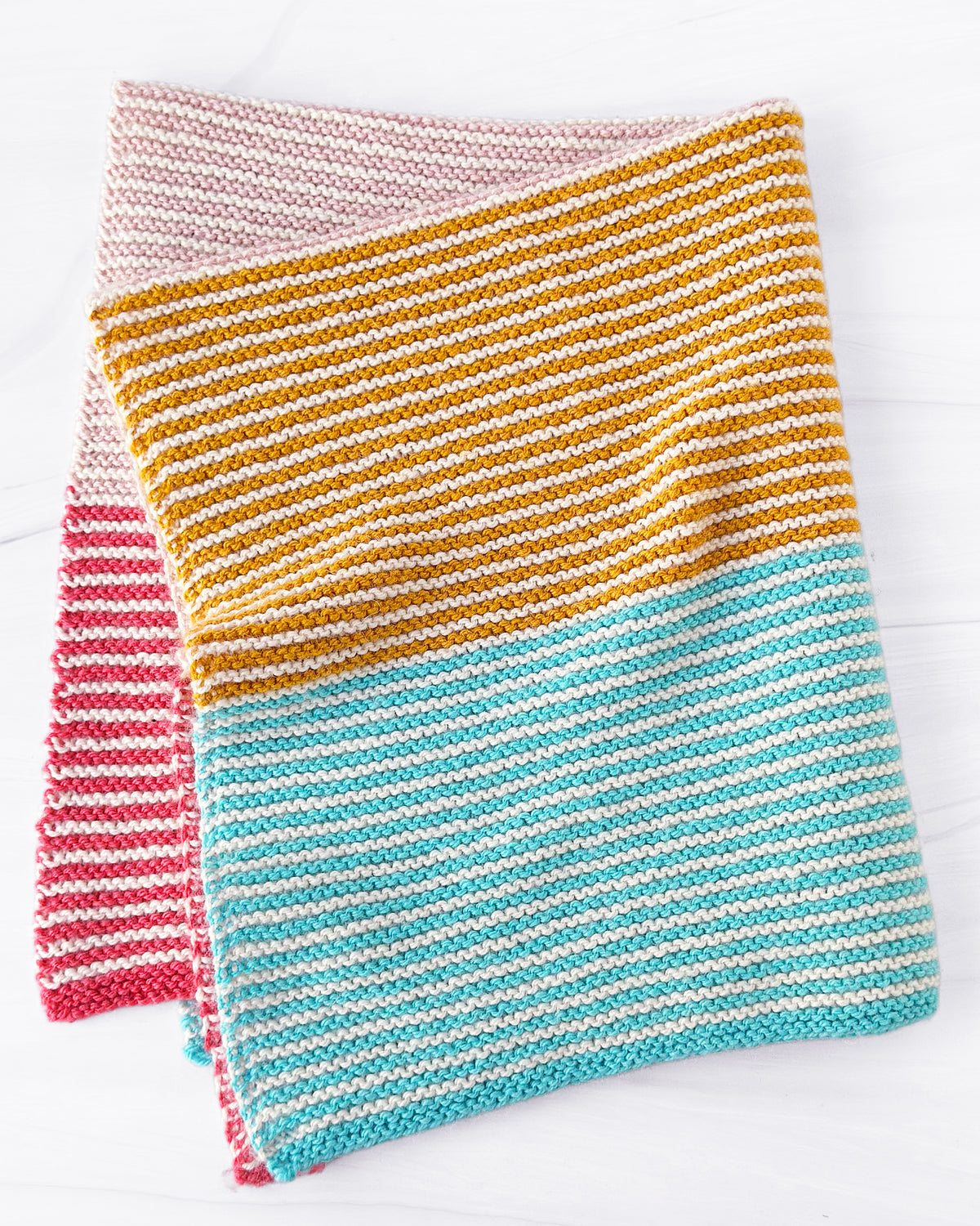 Seaside striped blanket in pink, gold, and turquoise