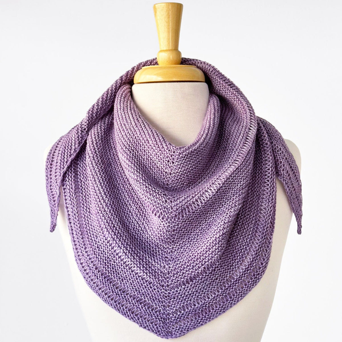 Purple knitted scarf on mannequin